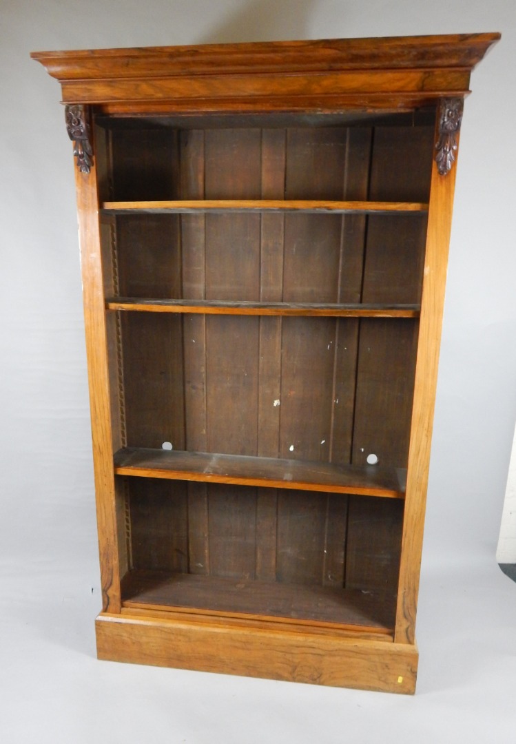 Appraisal: A Victorian rosewood open bookcase the outswept pediment above six