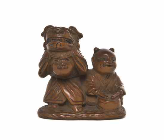 Appraisal: A Boxwood Netsuke depicting two boys one with a lion's