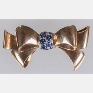 Appraisal: An kt Yellow and White Gold Sapphire Bow Form Brooch