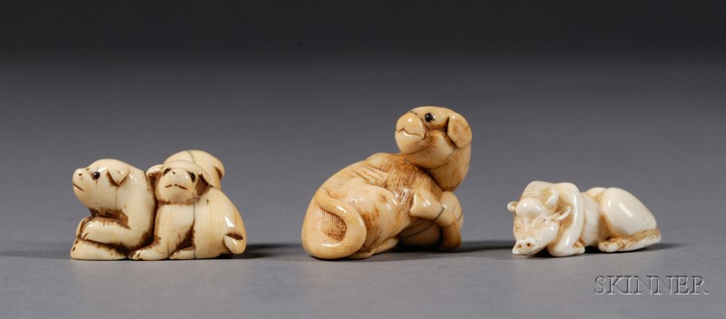 Appraisal: Three Ivory Netsuke th century a bull three puppies and