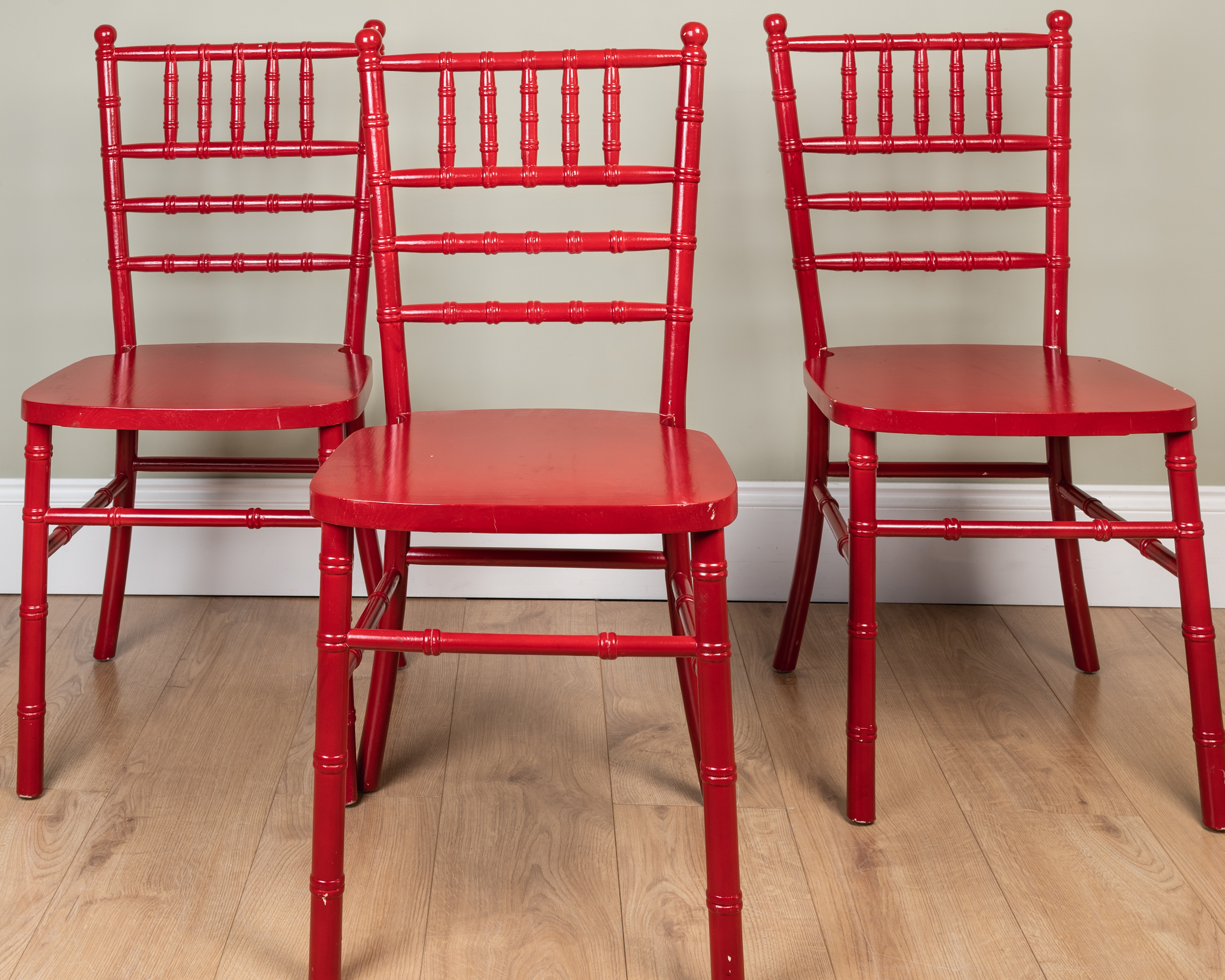 Appraisal: A set of three contemporary Chinese style red painted chairs