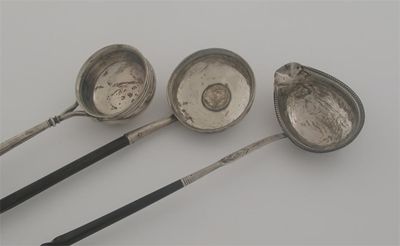 Appraisal: Three punch ladles a George III Scottish provincial example with