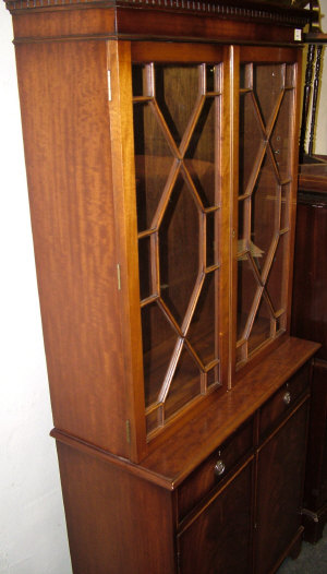 Appraisal: A Modern mahogany astragal glazed bookcase together with a modern