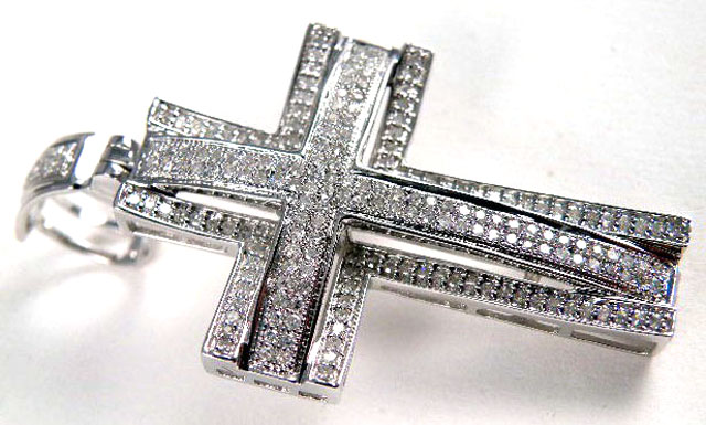 Appraisal: DIAMOND AND FOURTEEN KARAT GOLD PENDANT The cross pendant is