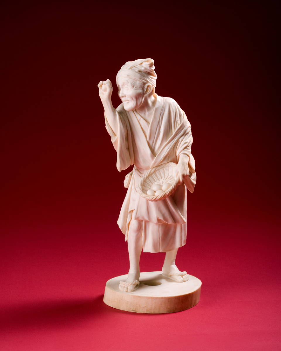 Appraisal: JAPANESE CARVED IVORY FIGURE OF AN ELDERLY MAN CARRYING A