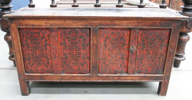 Appraisal: A Tibetan low storage cabinet front of four panels each