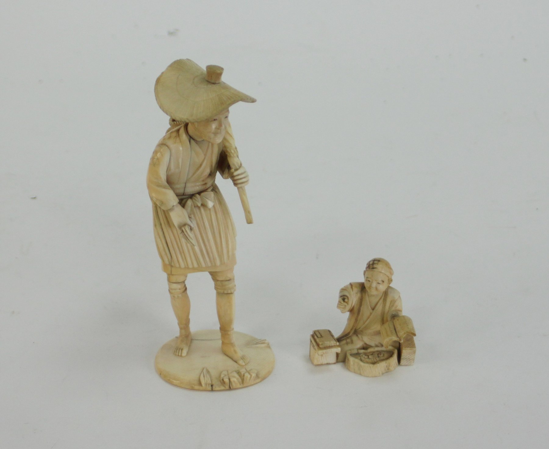 Appraisal: A Japanese ivory okimono depicting a man carrying a basket