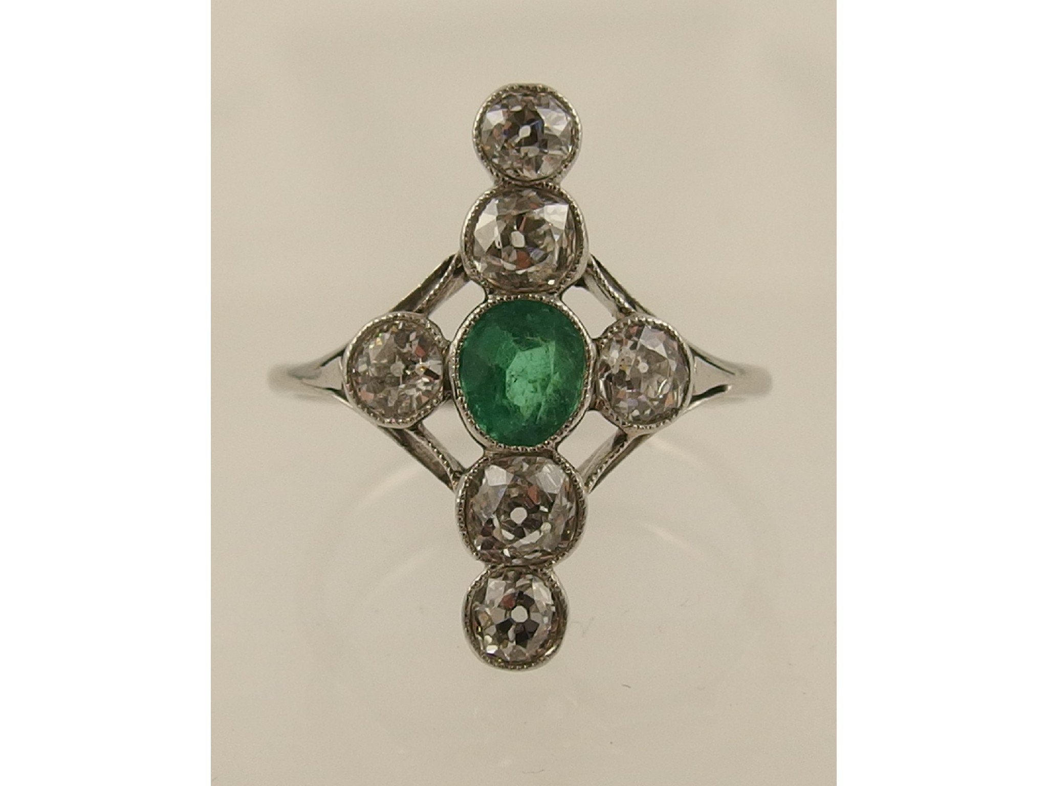 Appraisal: An emerald and diamond Edwardian ringfinely made in white metal