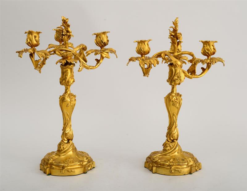 Appraisal: PAIR OF LOUIS XV STYLE GILT-BRONZE CANDLESTICKS FITTED WITH THREE-BRANCH