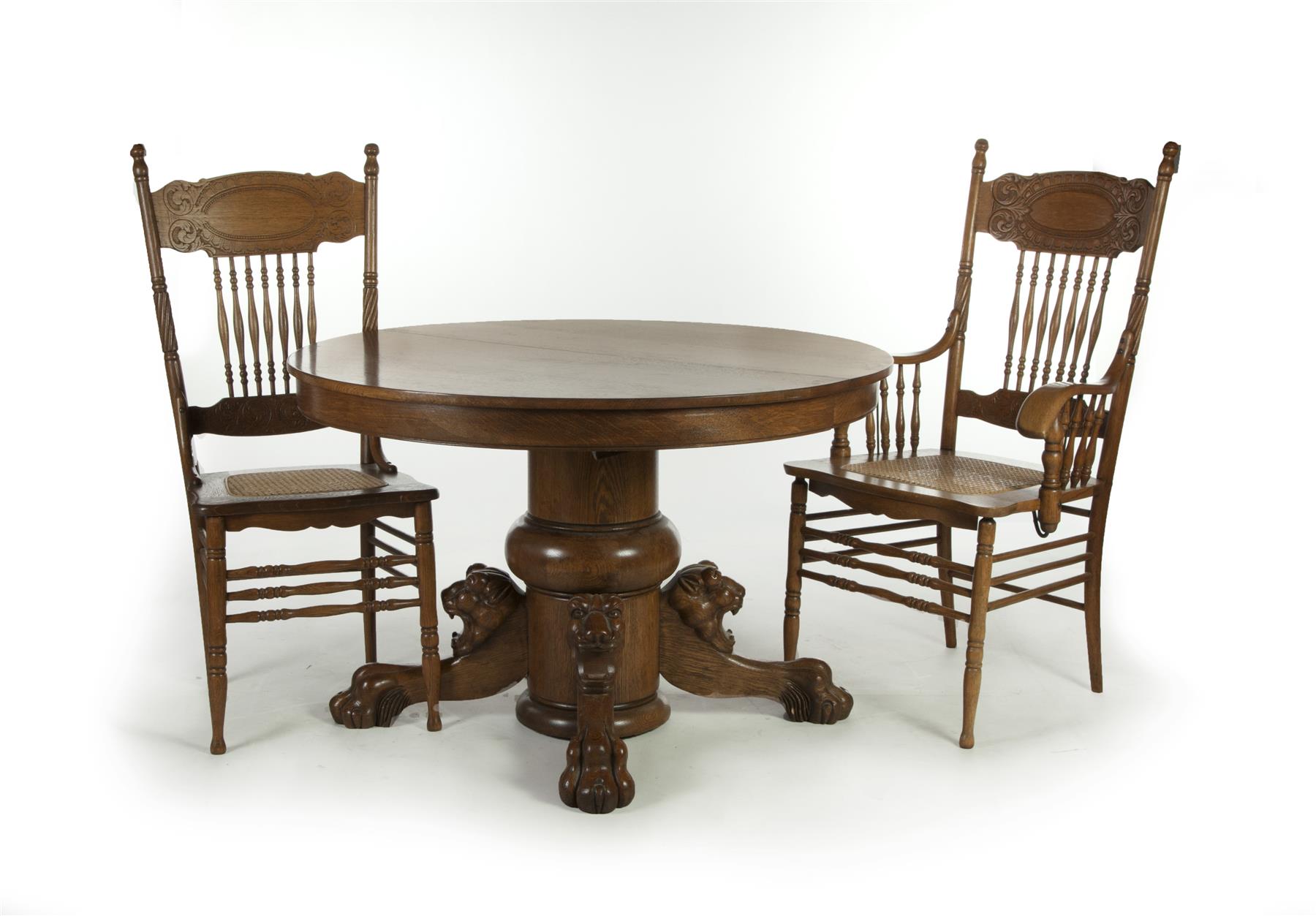 Appraisal: OAK PEDESTAL TABLE WITH TEN CHAIRS American ca Nicely carved