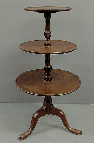 Appraisal: Georgian mahogany three-tier dumbwaiter with a reeded urn shaft and