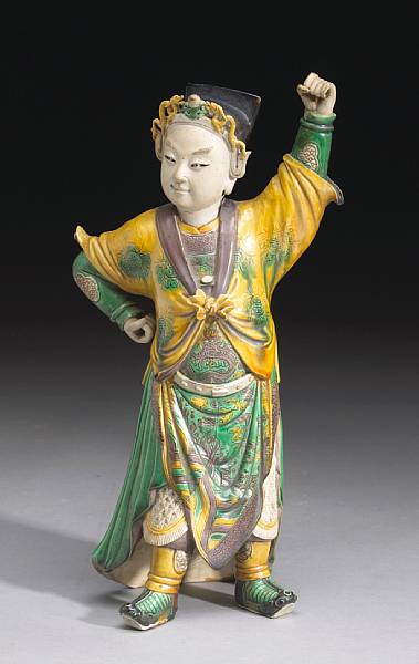 Appraisal: A three-color biscuit-glazed pottery figure of a performer in military