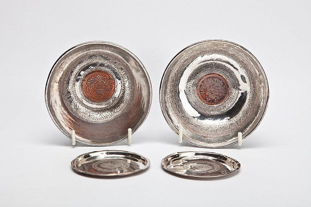 Appraisal: A PAIR OF PERSIAN SILVER SMALL BOWLS each inset Islamic