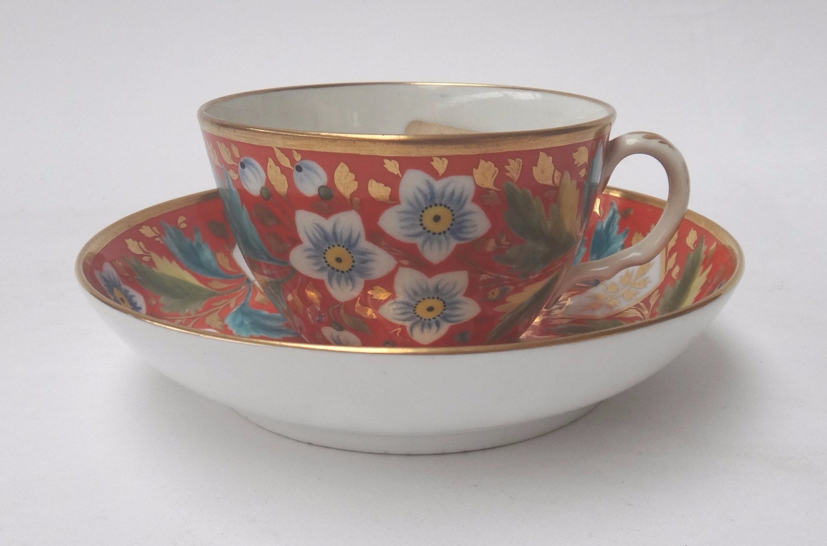 Appraisal: A Coalport Bute shaped teacup and saucer circa brightly painted