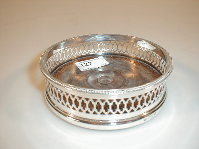 Appraisal: A modern silver wine coaster with a bead rim over