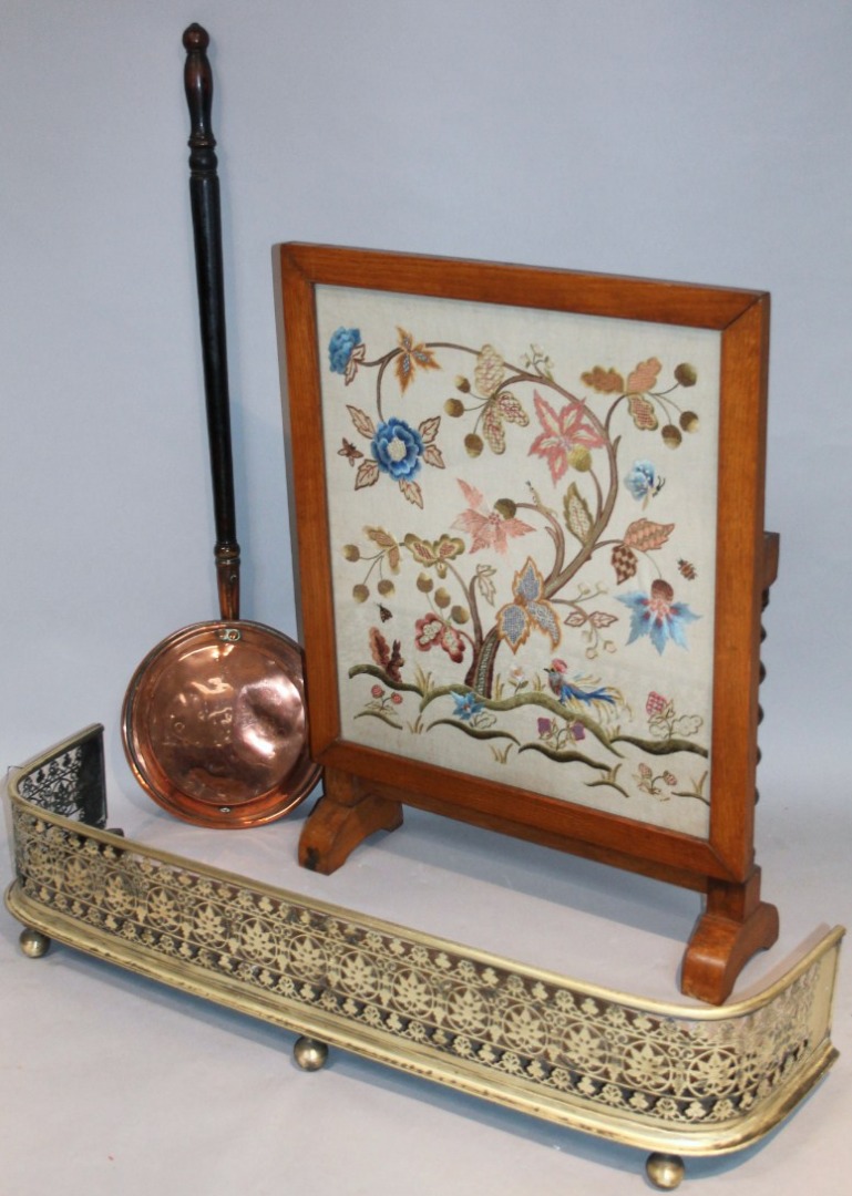 Appraisal: An Edwardian oak framed fire screen with embroidered centre set