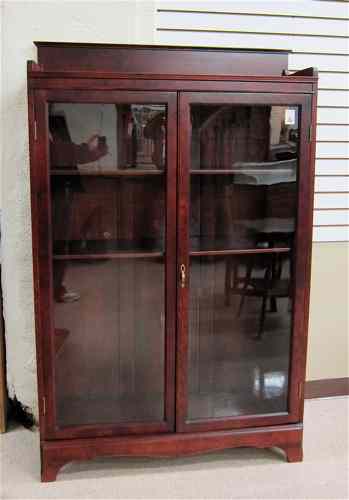 Appraisal: TWO-DOOR CABINET BOOKCASE American c of hardwood construction with mahogany