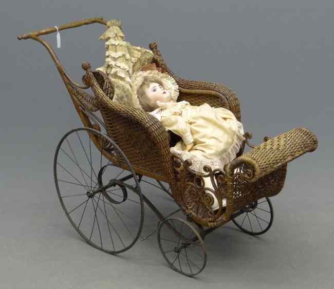 Appraisal: Victorian wicker baby carriage with reproduction Jumeau doll