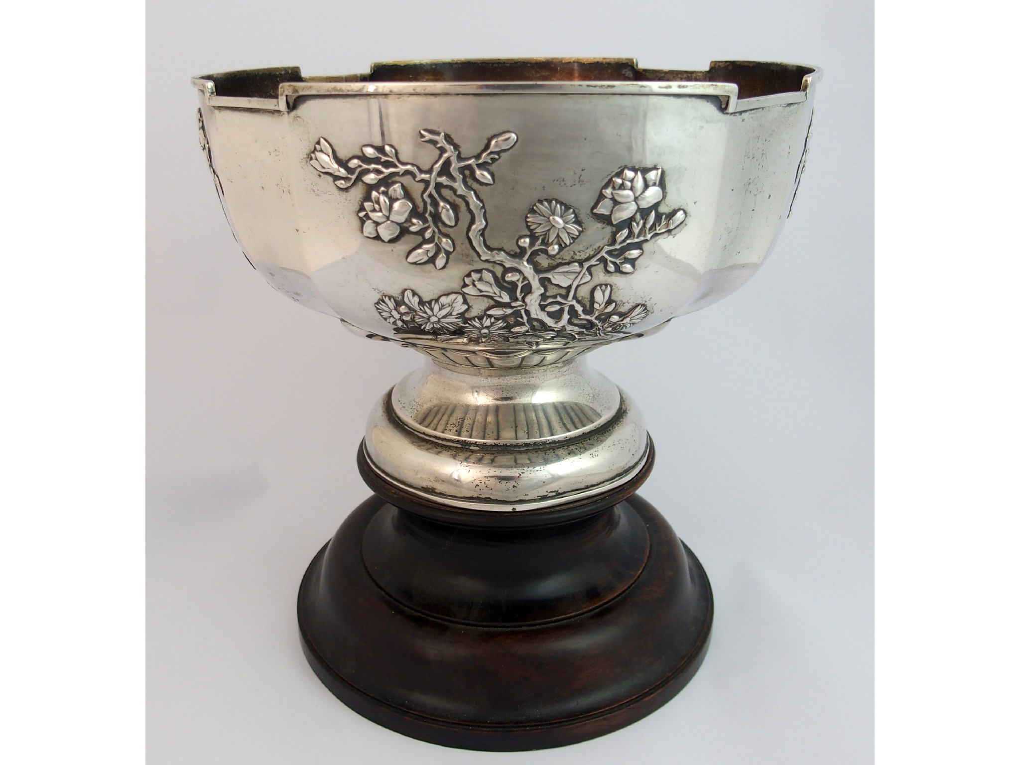 Appraisal: A Chinese silver punch bowlcast with four panels of blossoming