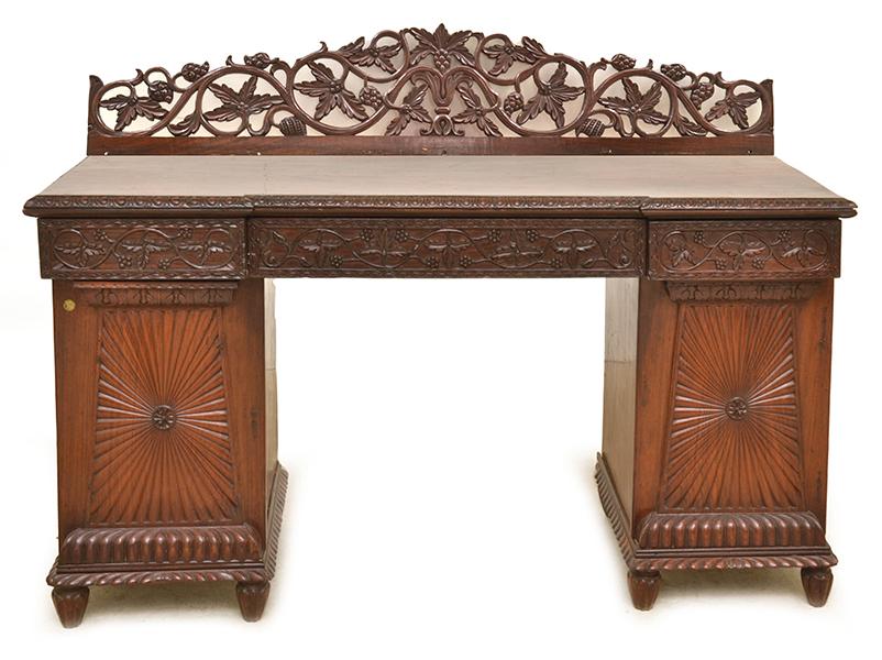 Appraisal: A TH CENTURY ANGLO-INDIAN TEAK PEDESTAL SIDEBOARD with a foliate