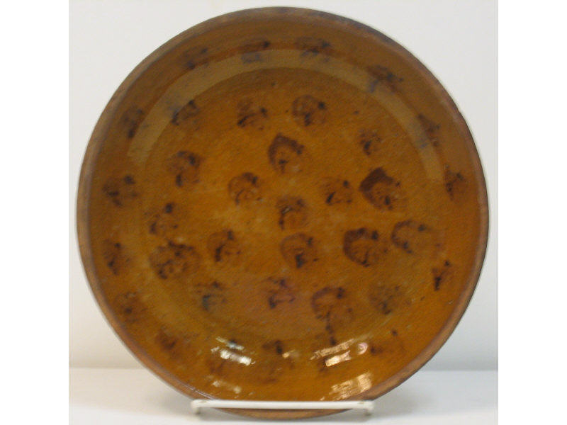 Appraisal: AMERICAN SLIP DECORATED REDWARE PIE PLATE Brown spots on orange