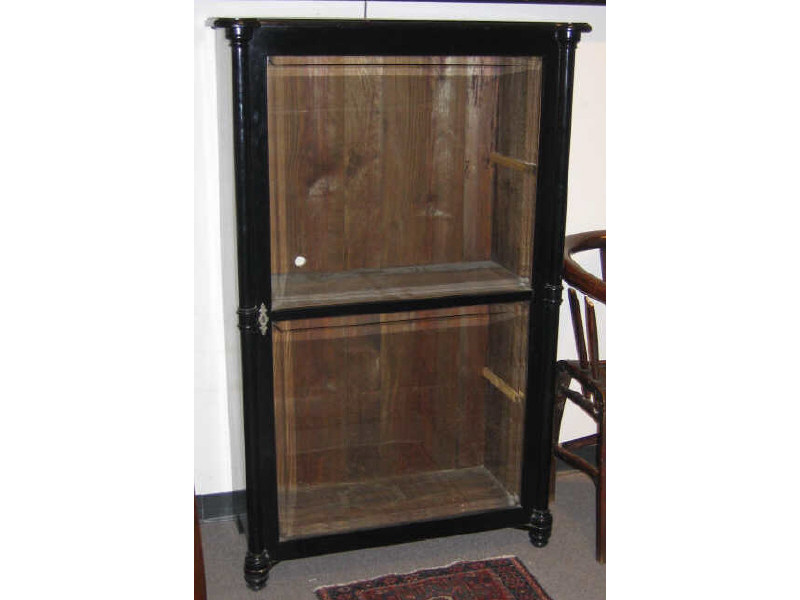 Appraisal: CONTINENTAL EBONIZED TALL DISPLAY CABINET Rectangular case with turret front