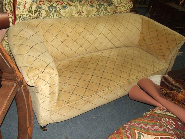 Appraisal: An Edwardian chesterfield settee standing on square tapering legs terminating