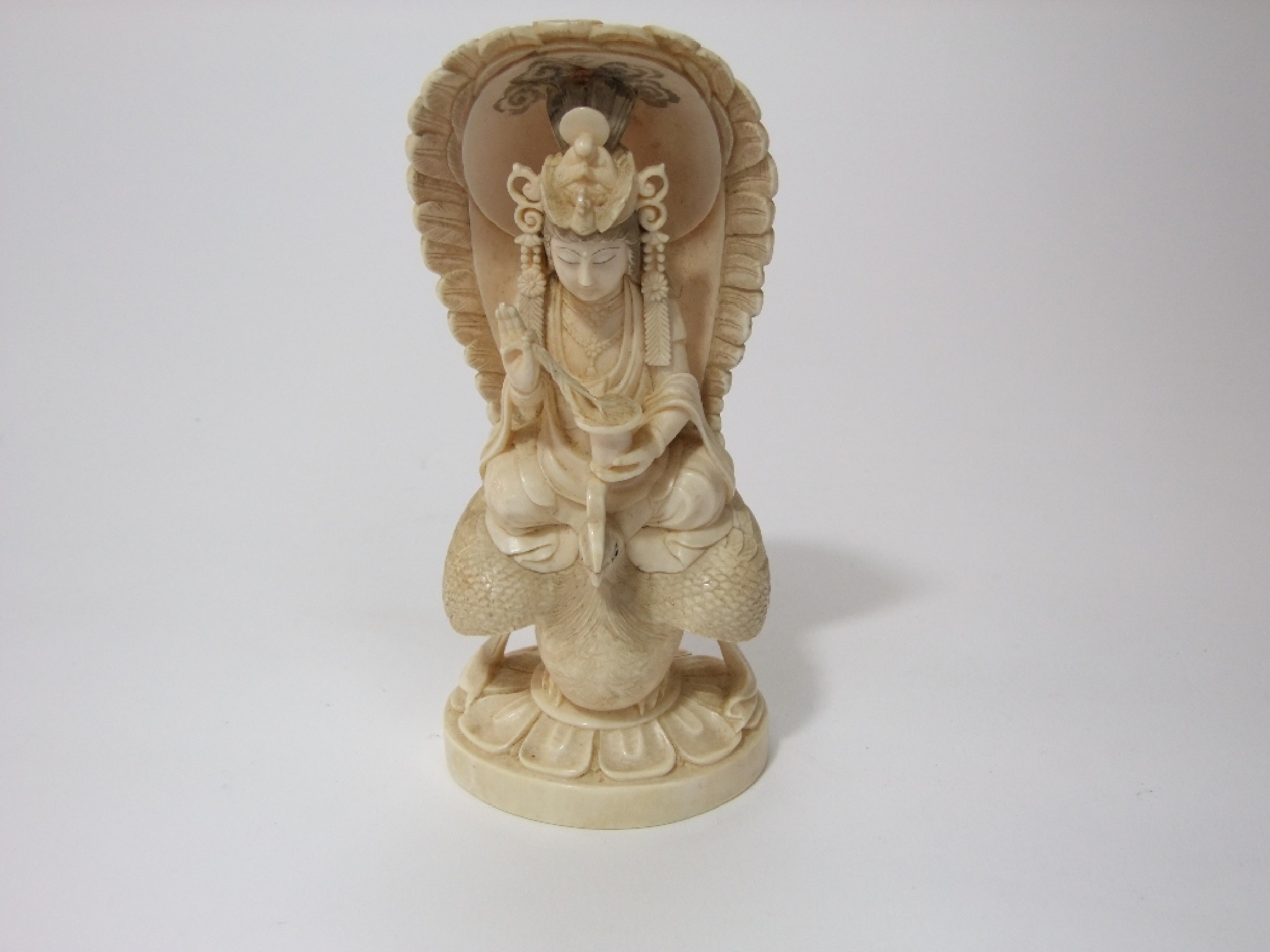 Appraisal: An oriental ivory okimono deity astride a rooster with red