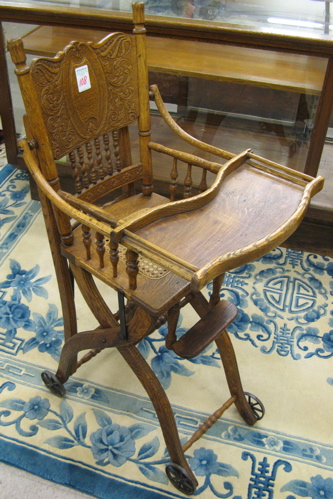 Appraisal: VICTORIAN PRESSED-BACK OAK HIGHCHAIR STROLLER American c The highchair has