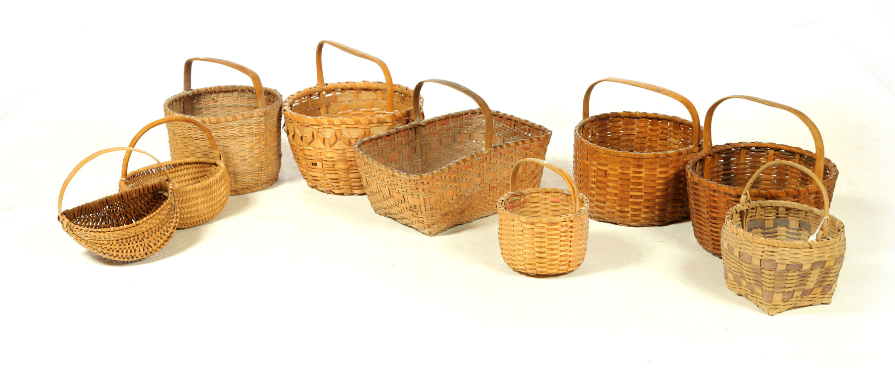 Appraisal: NINE BASKETS American th century woven splint One half buttocks