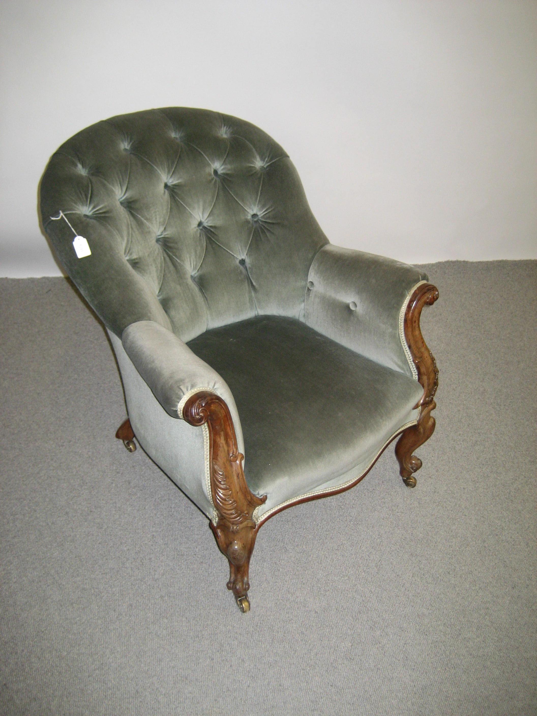 Appraisal: A VICTORIAN WALNUT FRAMED ARMCHAIR of spoonback form button upholstered