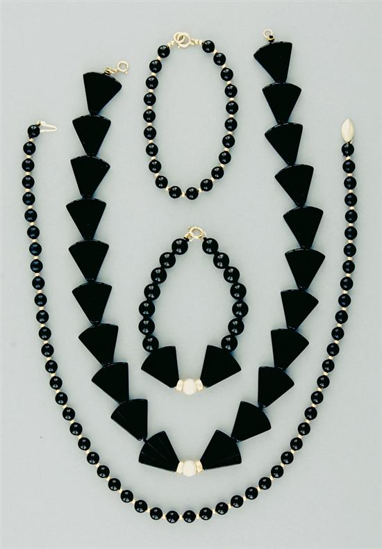 Appraisal: Black onyx demi-parures twenty-one fan shaped onyx beads mm centered