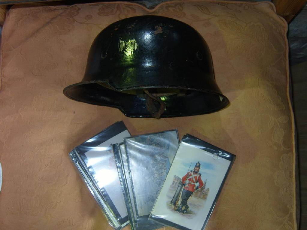 Appraisal: A WWII German helmet and a number of military postcards