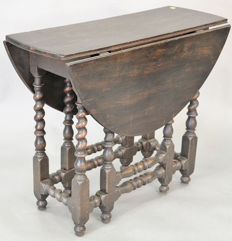 Appraisal: Oak stained gate leg drop leaf table with spiral turned