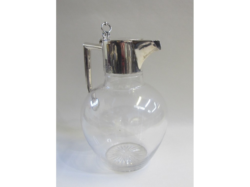 Appraisal: Silver mounted claret jug in the style of Christopher Dresser