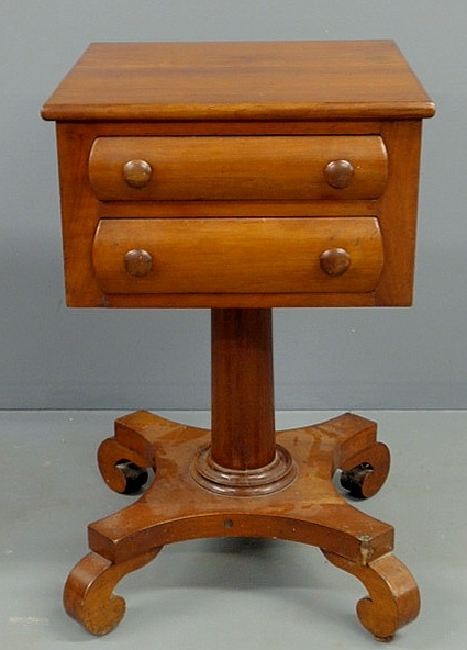 Appraisal: Empire cherry two-drawer stand with a column shaft and down-scrolled