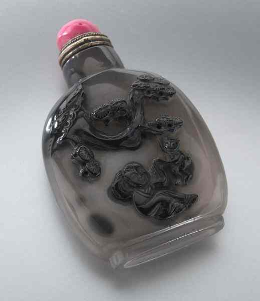 Appraisal: Chinese carved agate snuff bottledepicting a boy under a pine