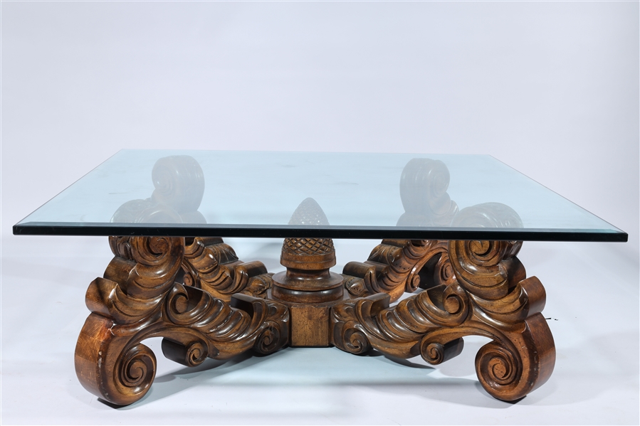 Appraisal: Coffee table with elaborate wood carved base and square glass