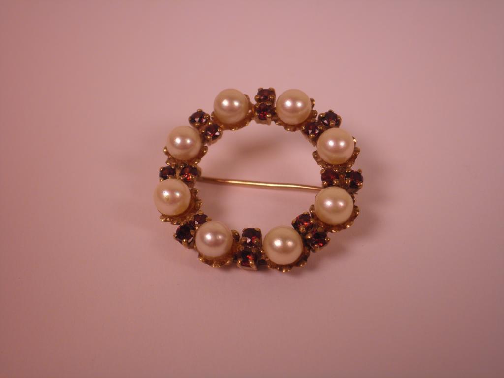 Appraisal: A carat gold pearl and red stone brooch