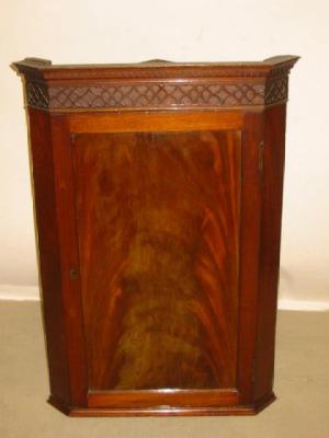 Appraisal: A GEORGE III MAHOGANY CORNER CUPBOARD the moulded and dentil