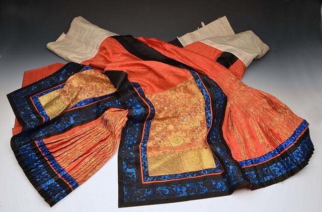 Appraisal: A PAIR OF CHINESE RED SKIRTS each with multiple pleats