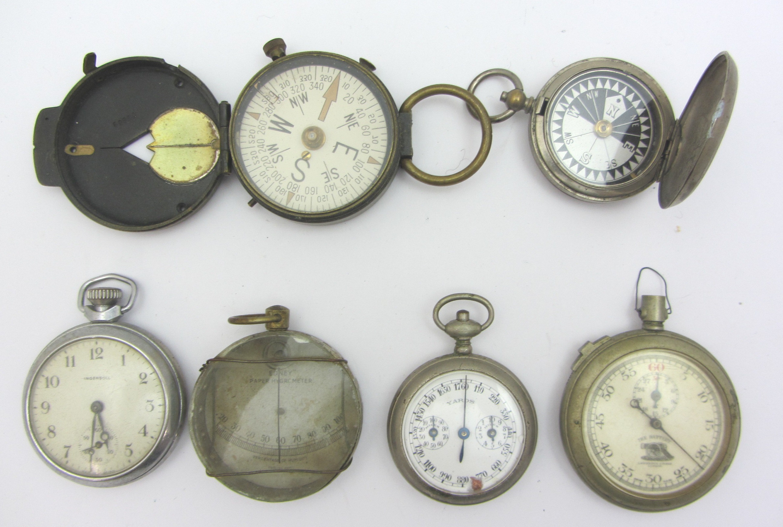 Appraisal: An openfaced stop watch detailed The Battery a pocket compass