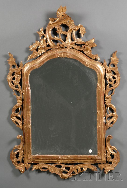 Appraisal: Italian Rococo Giltwood Mirror th century cartouche-shaped plate within a