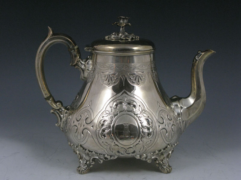 Appraisal: Silverplate Teapot English early th c having engraved footed design