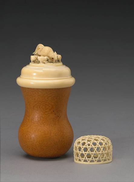 Appraisal: An ivory-mounted gourd cricket cage The bulbous gourd body burnt