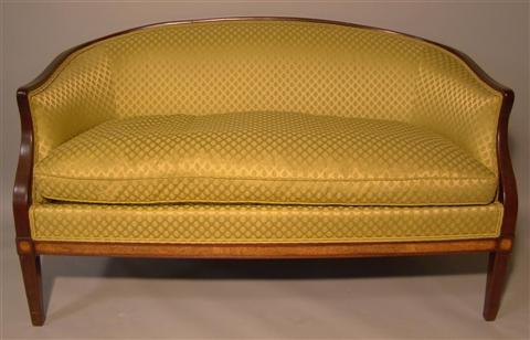 Appraisal: REGENCY STYLE MAHOGANY UPHOLSTERED SETTEE The sloped back upholstered in