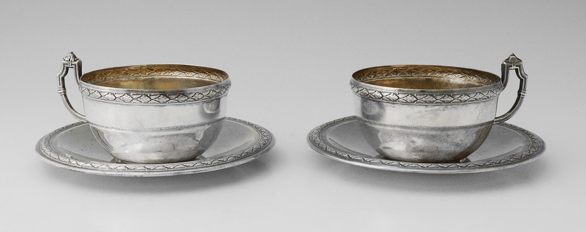 Appraisal: CONTINENTAL FINE SILVER TEA CUPS SAUCERS Embossed rim bands with