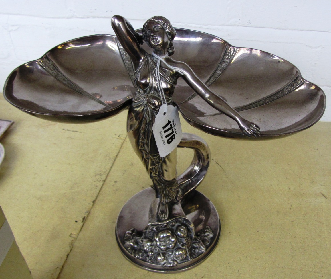 Appraisal: A WMF style silvered metal figural tazza circa modelled and