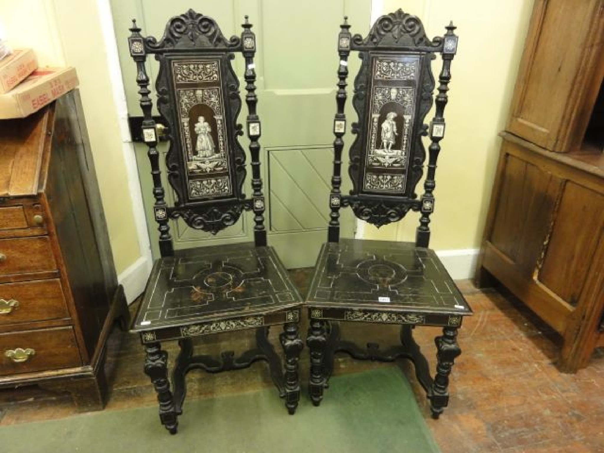 Appraisal: A pair of th century ebonised high back side chairs