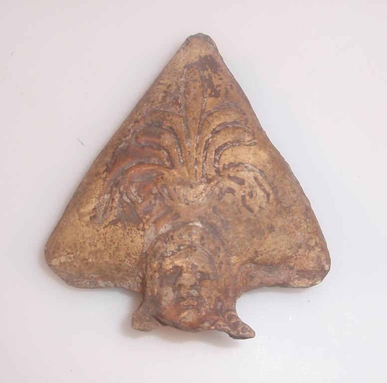 Appraisal: A moulded Roman terracotta fragment from the triangular handle guard